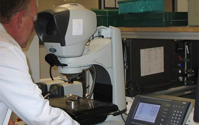 man using optical measuring system to inspect pressure sensors